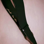 Black leather paddle with custom gold engraving example – personalized text BDSM impact play paddle detail
