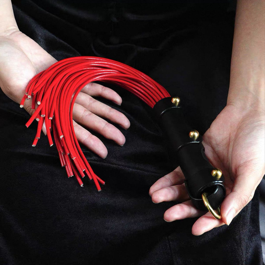 Red leather cowhide whip held in both hands – black leather handle gold rivet O-ring BDSM impact play handmade
