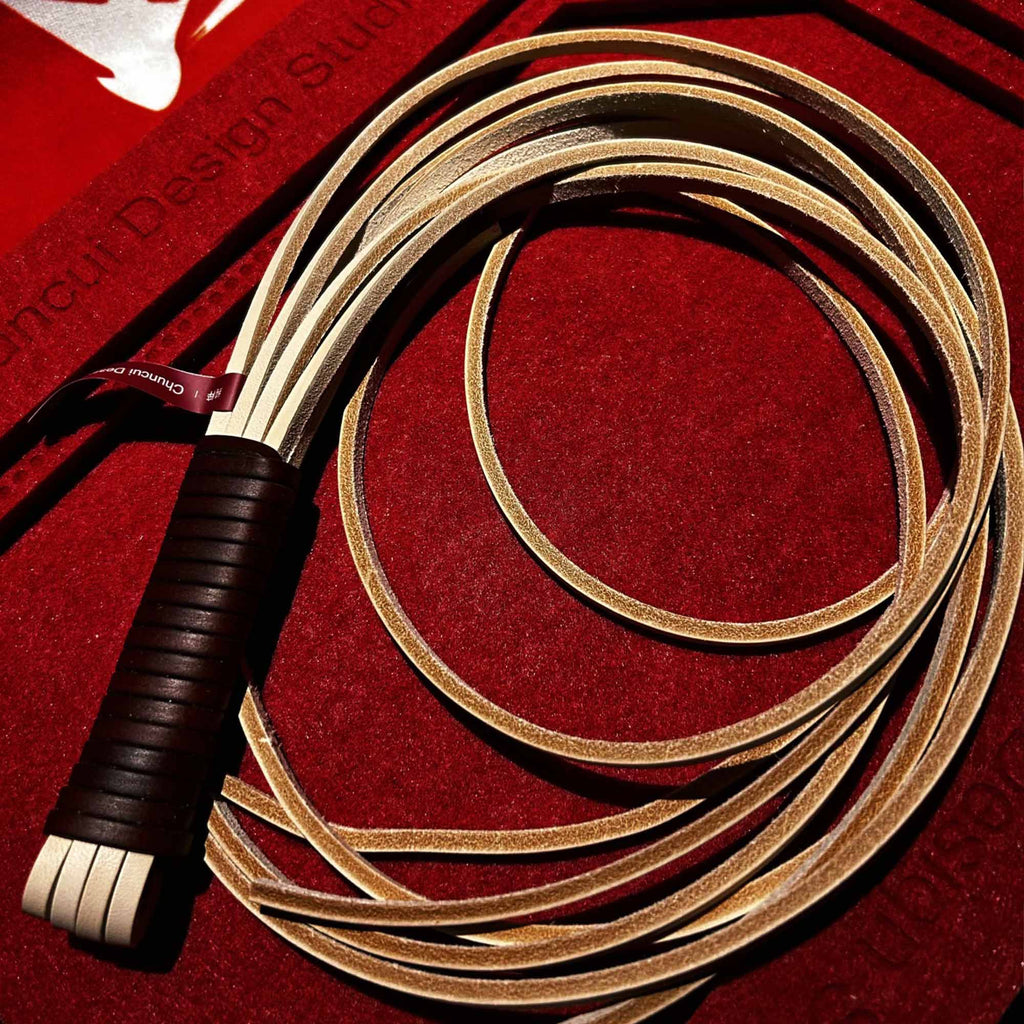 Natural vegetable tanned leather flogger product display – cream tails dark brown wrapped handle BDSM impact play handmade ShadowedBodies
