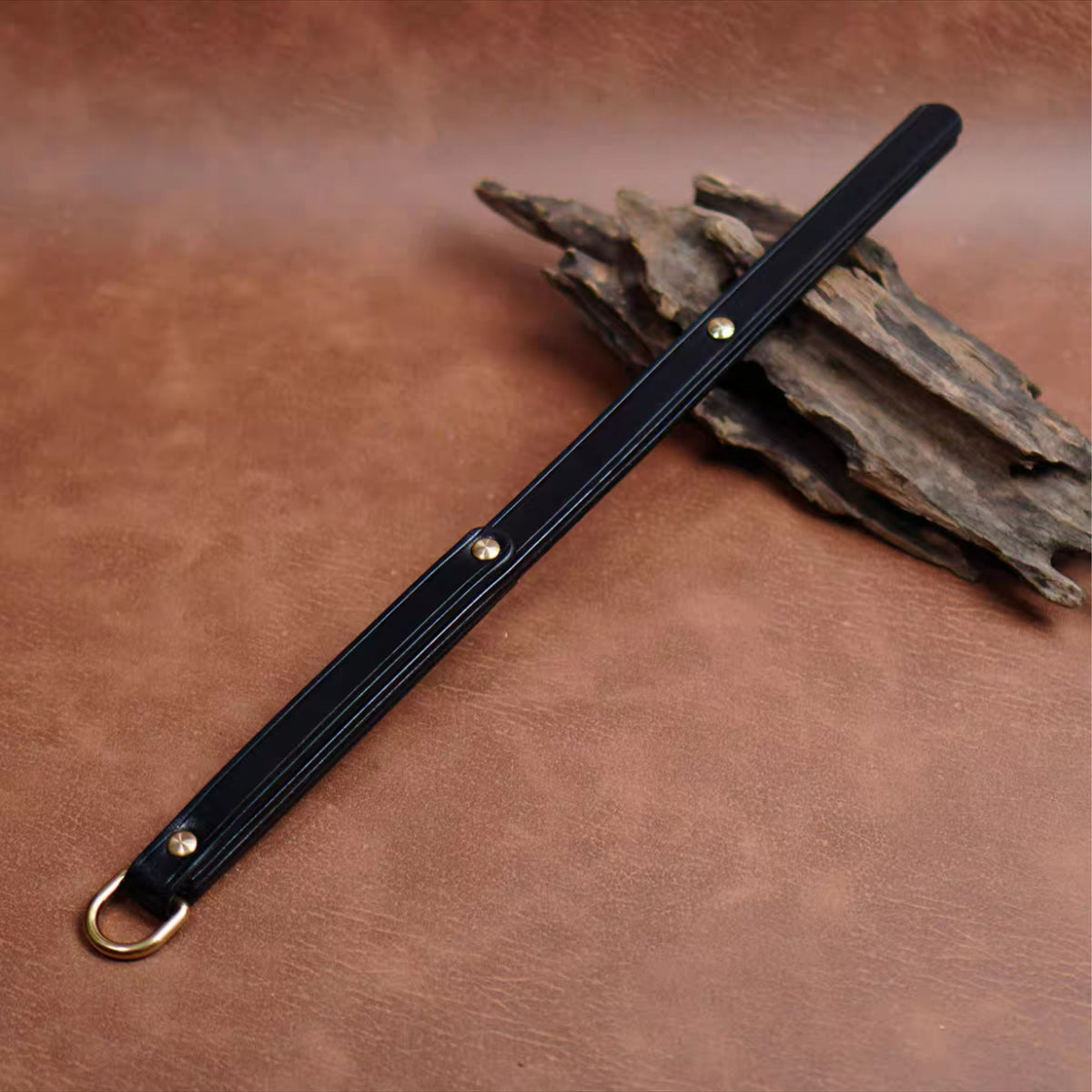 Black full grain cowhide leather whip product display – gold rivet D-ring BDSM impact play crop handmade ShadowedBodies
