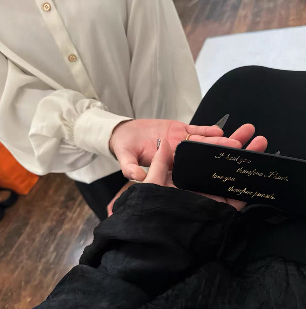 Black leather paddle in use by model – lifestyle editorial BDSM impact play handmade vegetable tanned
