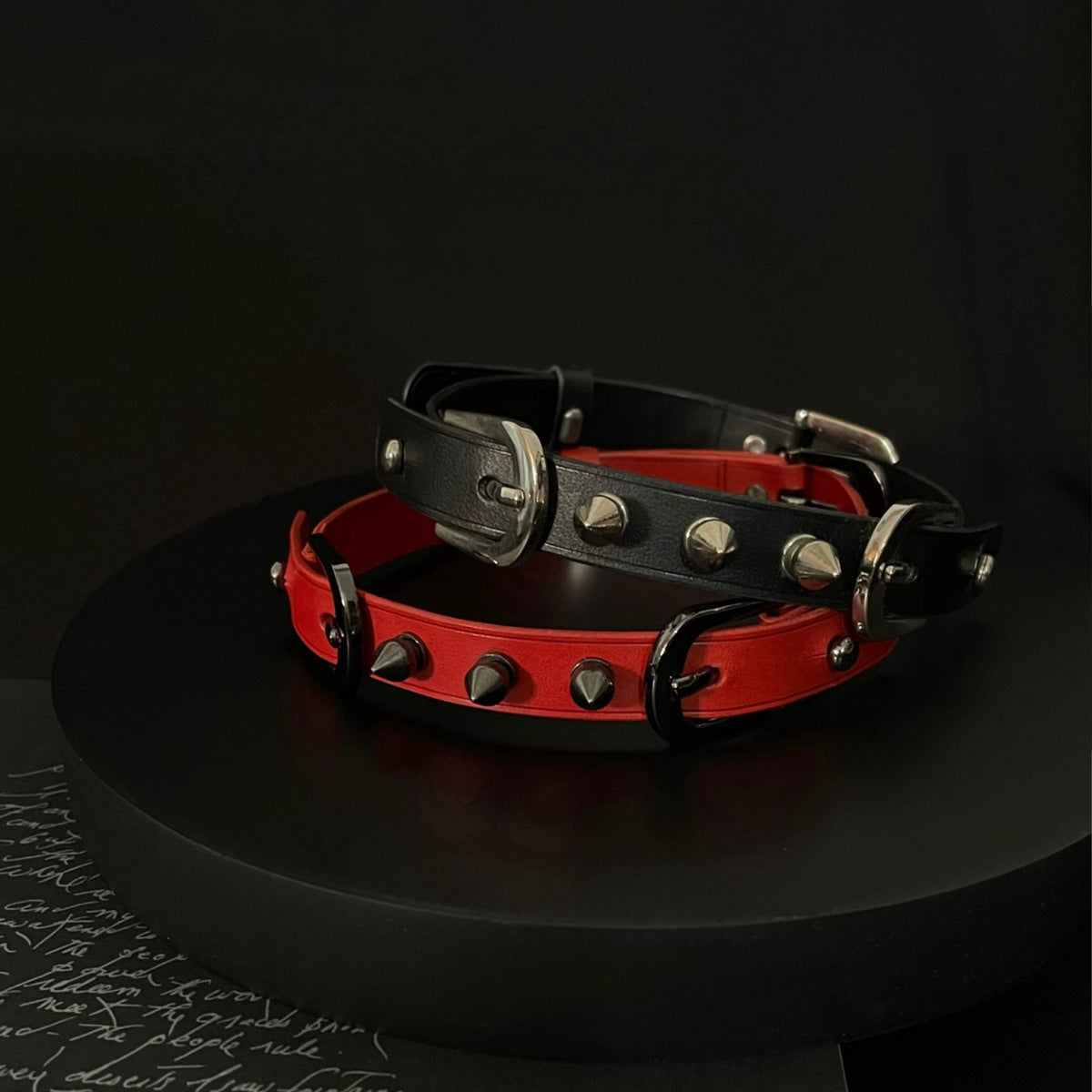Matte red and black leather spiked BDSM chokers side by side – two color versions black and silver hardware comparison
