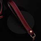 Burgundy leather leash strap detail – red saddle stitching gold dome rivet O-ring connector handmade
