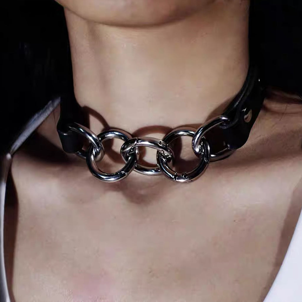 Front view of model wearing black leather collar linked together by three interlocking silver spring O-rings