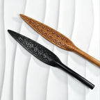 Black tooled and natural oil-dyed tooled leather paddles displayed together – intricate carved floral pattern leaf blade BDSM handmade comparison
